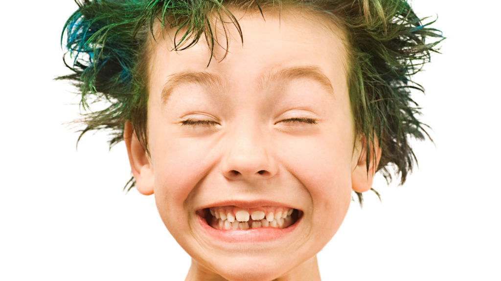 boy smiling with green hair dye