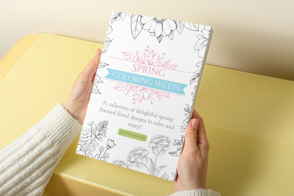 spring coloring sheets book held by a person above a yellow table or shelf